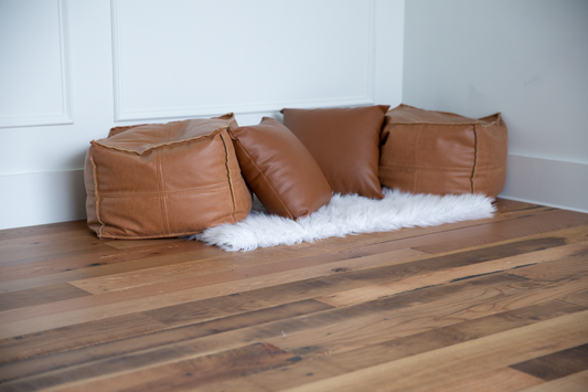 light rustic barnwood flooring, with pillows
