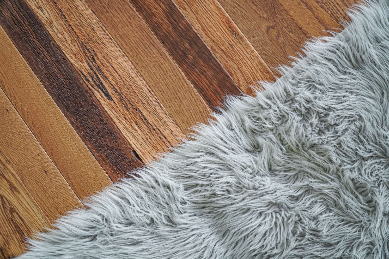 wood boards under grey carpet